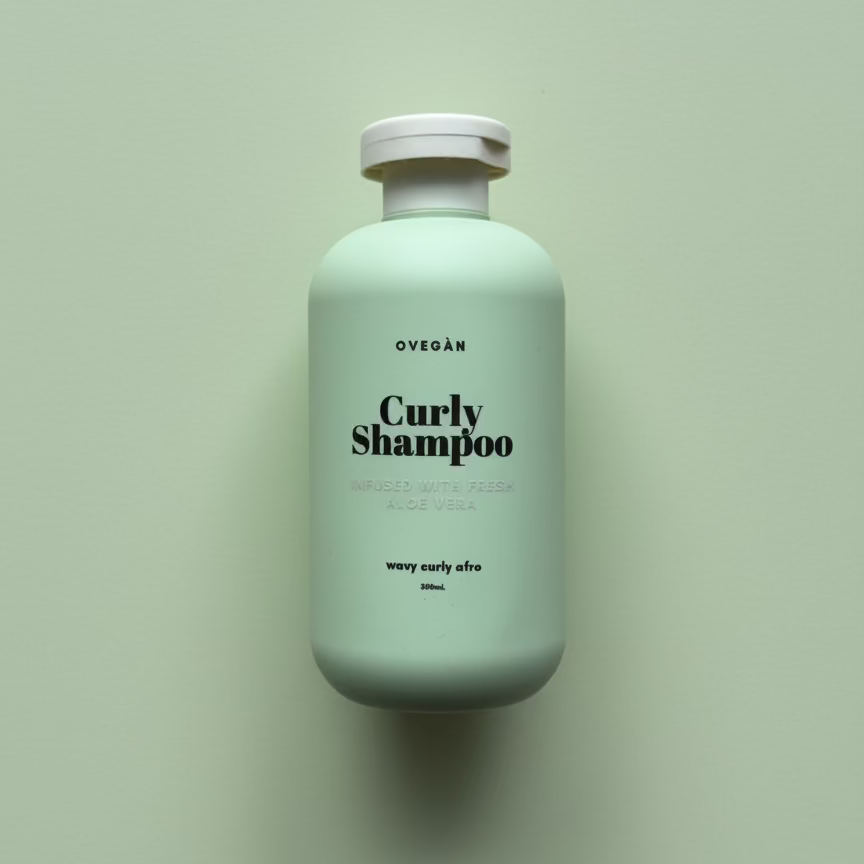 Mint green shampoo bottle labeled 'Curly Shampoo' on a light green background