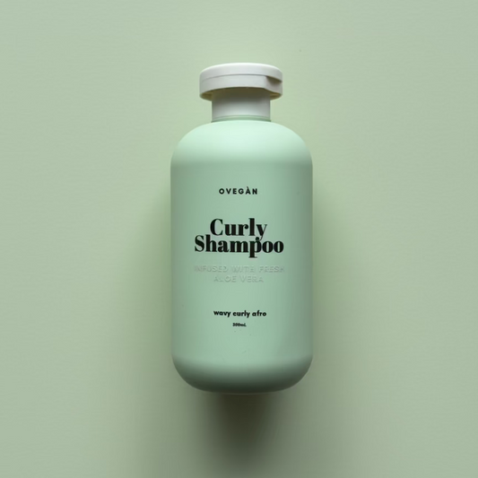Mint green shampoo bottle labeled 'Curly Shampoo' on a light green background