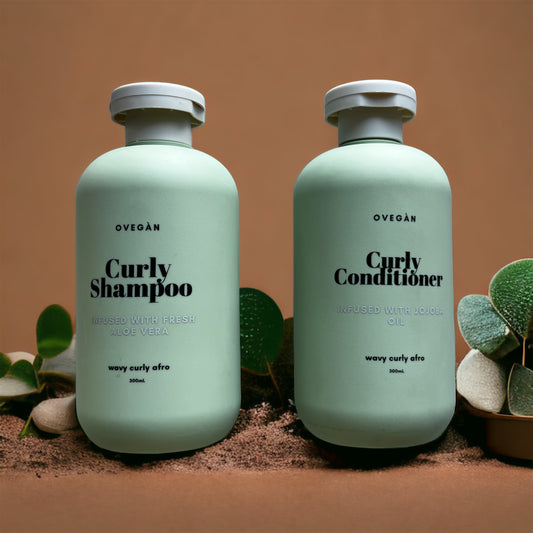 Two bottles, one labeled 'Curly Shampoo' and the other 'Curly Conditioner', both with aloe vera imagery, presented on a surface with some foliage.